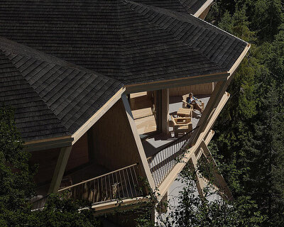 fragmented timber volumes compose forested mountain housing by arup in albania