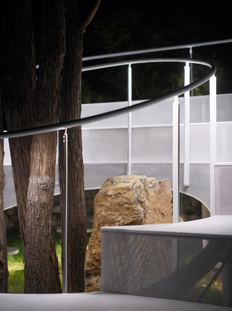 the circular geometry of the installation encircles a solitary rock