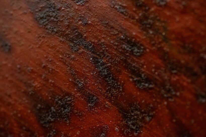 red-painted steel panels, where layers of rust create a rich and distinctive texture