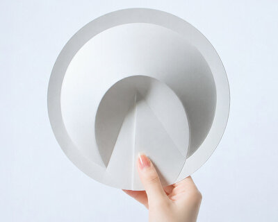 a ribless circular folded sculpture reimagines the traditional japanese paper fan