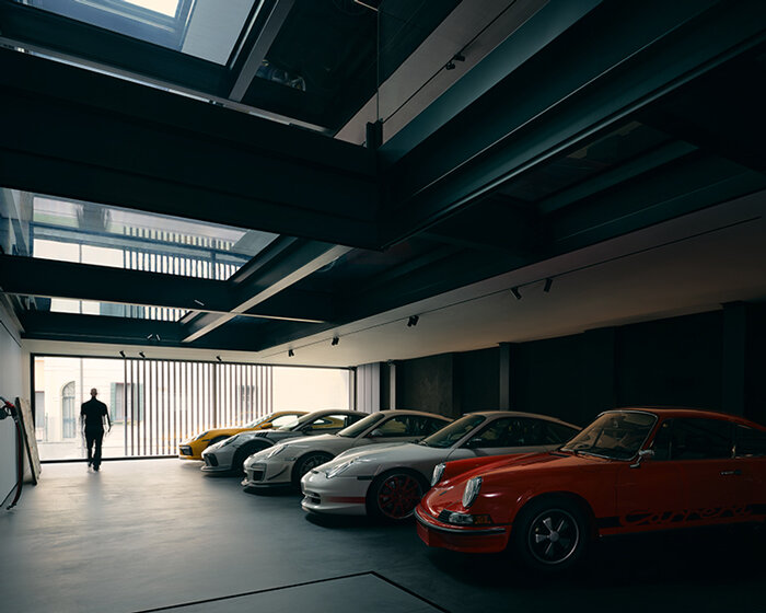 black resin, glass, and steel shape alessandro isola's automotive sanctuary in italy