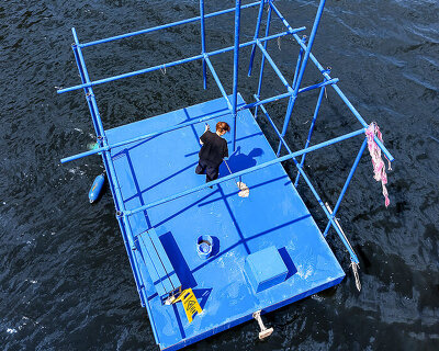 an endless act of cleaning unfolds on a floating platform in berlin
