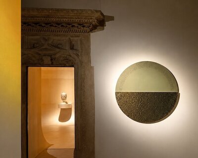 sculptural exhibition design traces a glowing path through antiquity in poland
