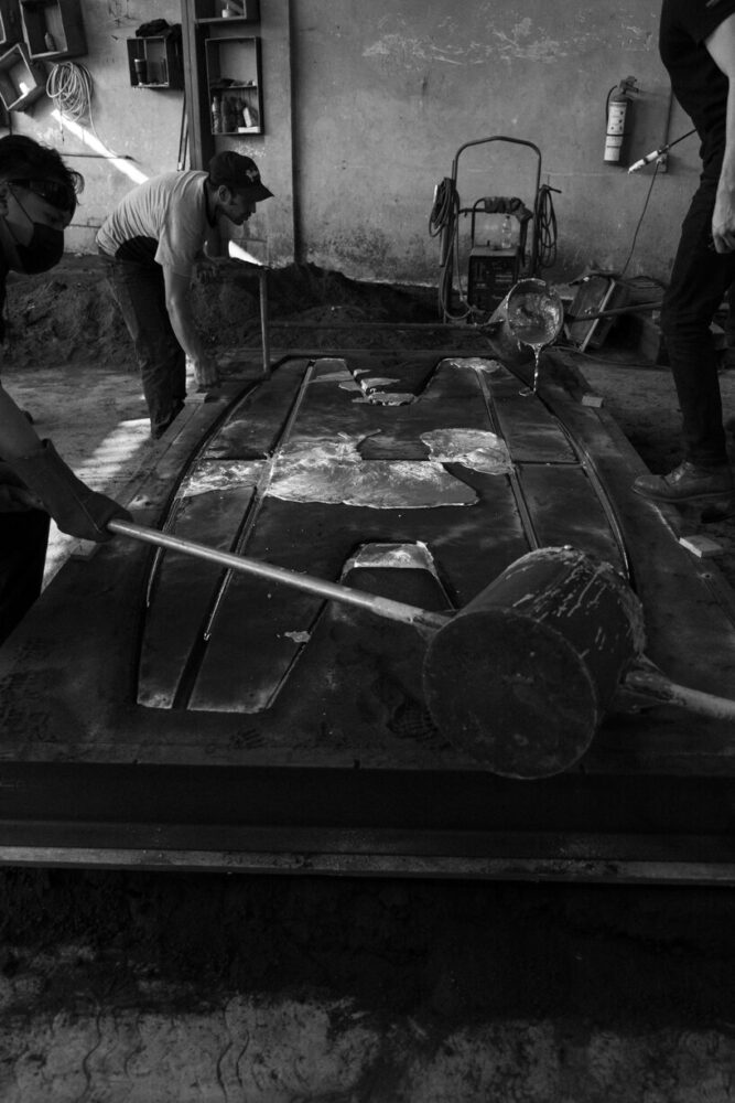 molten aluminum is poured into the hand-made sand mold, capturing the form of the Exhuma Dining Table