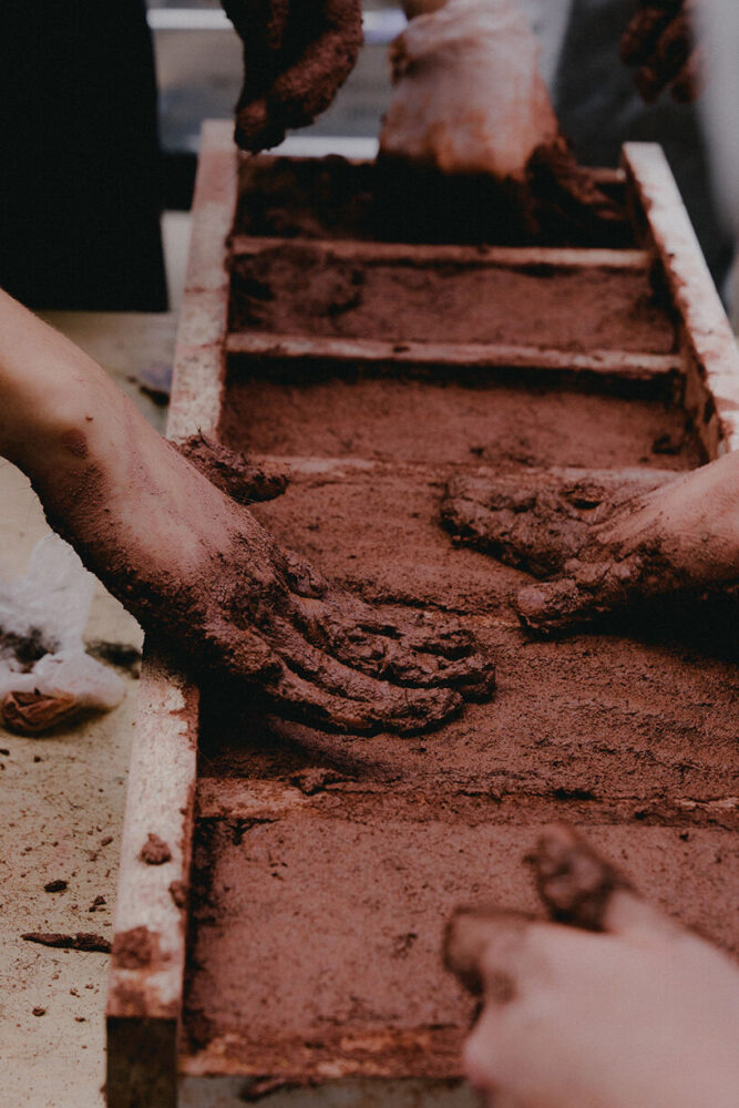 moulds for hair-reinforced clay bricks with local participants at Carpenters Garden