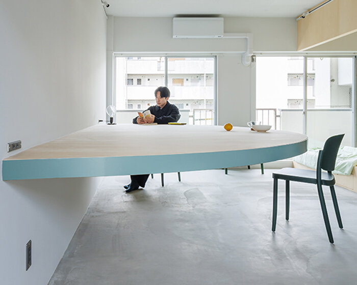 giant blue-green semicircular table by tato architects reorganizes kyoto apartment
