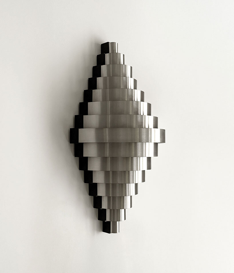Multiplight piece uses layered sheet metal to guide and diffuse illumination