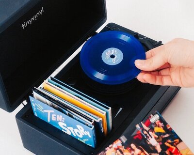 tiny vinyl player spins four-inch records on a miniature turntable