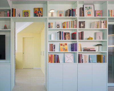 opal-green bookcase reframes casa pop in madrid around color and cinematic references