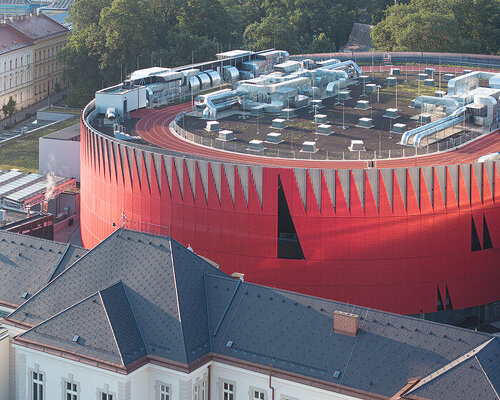 CHYBIK + KRISTOF wraps jihlava arena in a jagged red aluminum crown