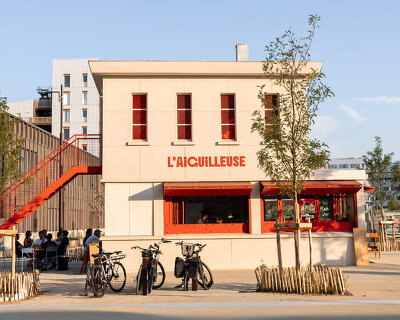 former railway signal box reopens as l'aiguilleuse red-orange kiosk-bar in nantes
