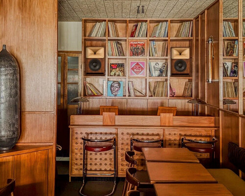 SOBO wraps paris listening restaurant in oak, vintage furniture, and acoustic panels