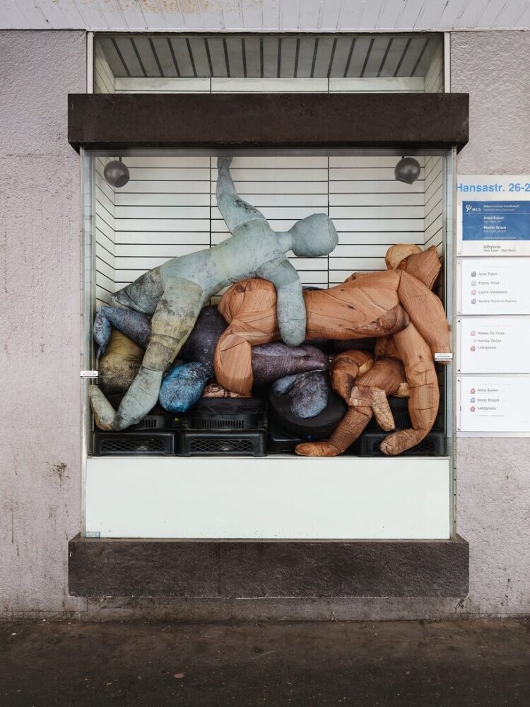 greeting visitors is a pile of inflatable figures pressing up against a glass case that would have formerly housed optical advertisements or product offerings
