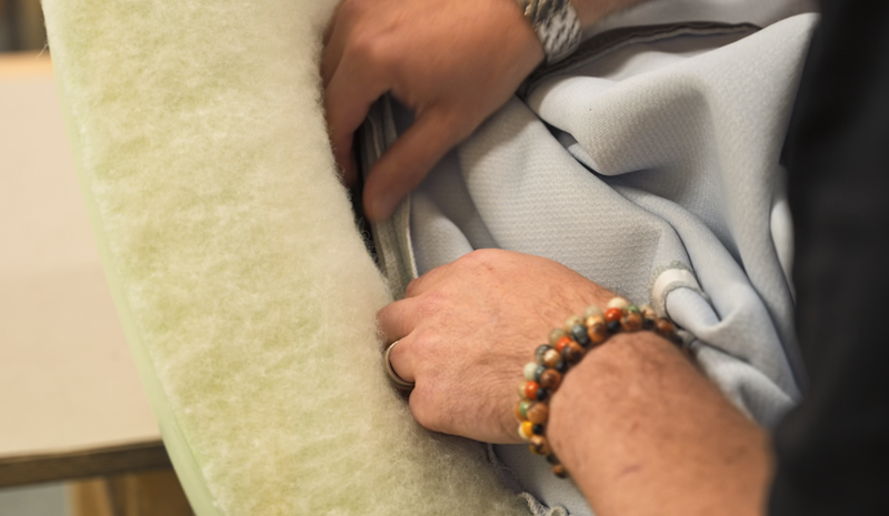 hands working on upholstery