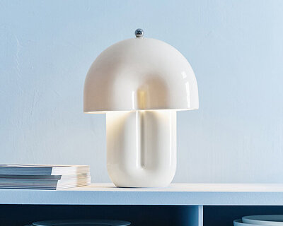 split ceramic curves cast soft reflected light in dimmable table lamp
