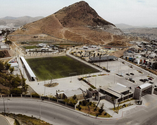 open fields and concrete paths create shared sports landscape in tijuana