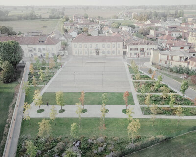 fifty oak trees and stone-paved clearing shape contemporary italian piazza by ghisellini architetti