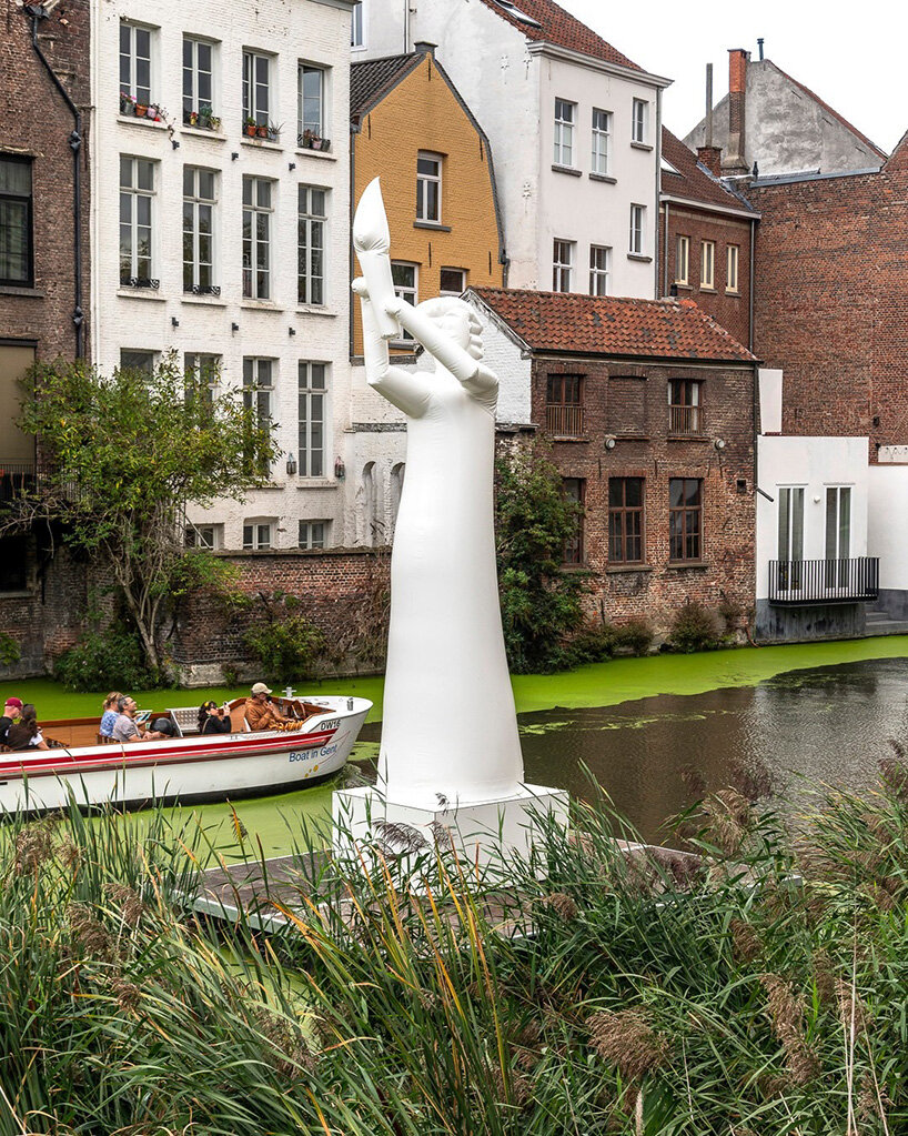     the seven-meter-high figure stands on a floating platform in the moat