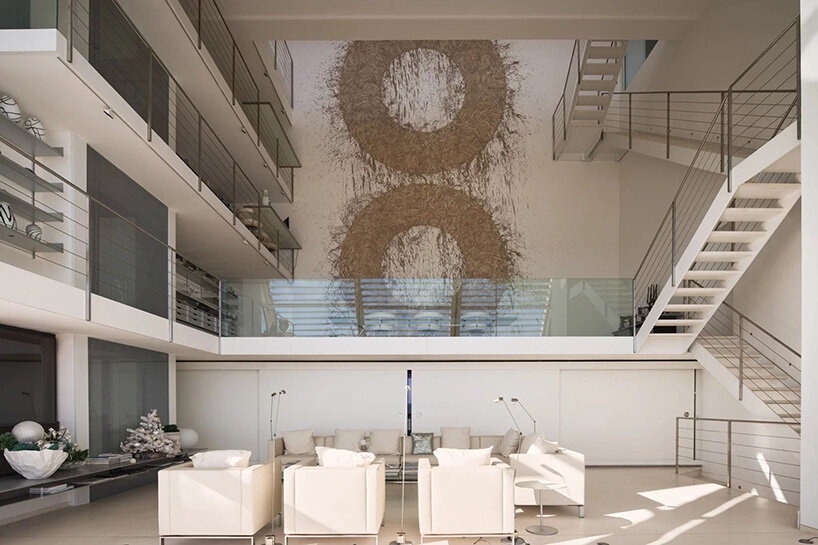 double-height living room with Richard Long’s MudWork fresco and upper-level walkways
