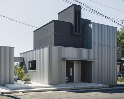 glazed passage frames lake views through this compact japanese house