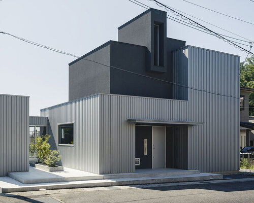 glazed passage frames lake views through this compact japanese house
