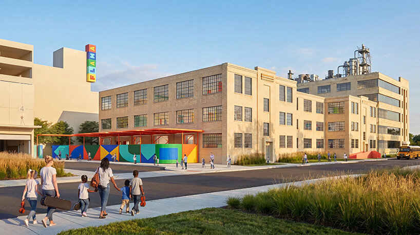 Exterior view of FLAMA showing the restored industrial brick facade, original grid windows, colorful courtyard structures, and school entrance