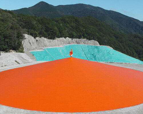 ryue nishizawa places vivid orange peak against turquoise landfill in japan