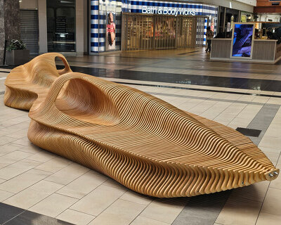 undulating plywood layers form stratum parametric public seating sculpture