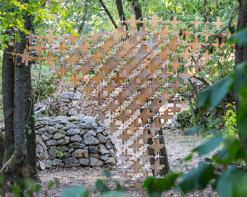 interlocking biodegradable modules weave regenerative pavilion into gavarres landscape